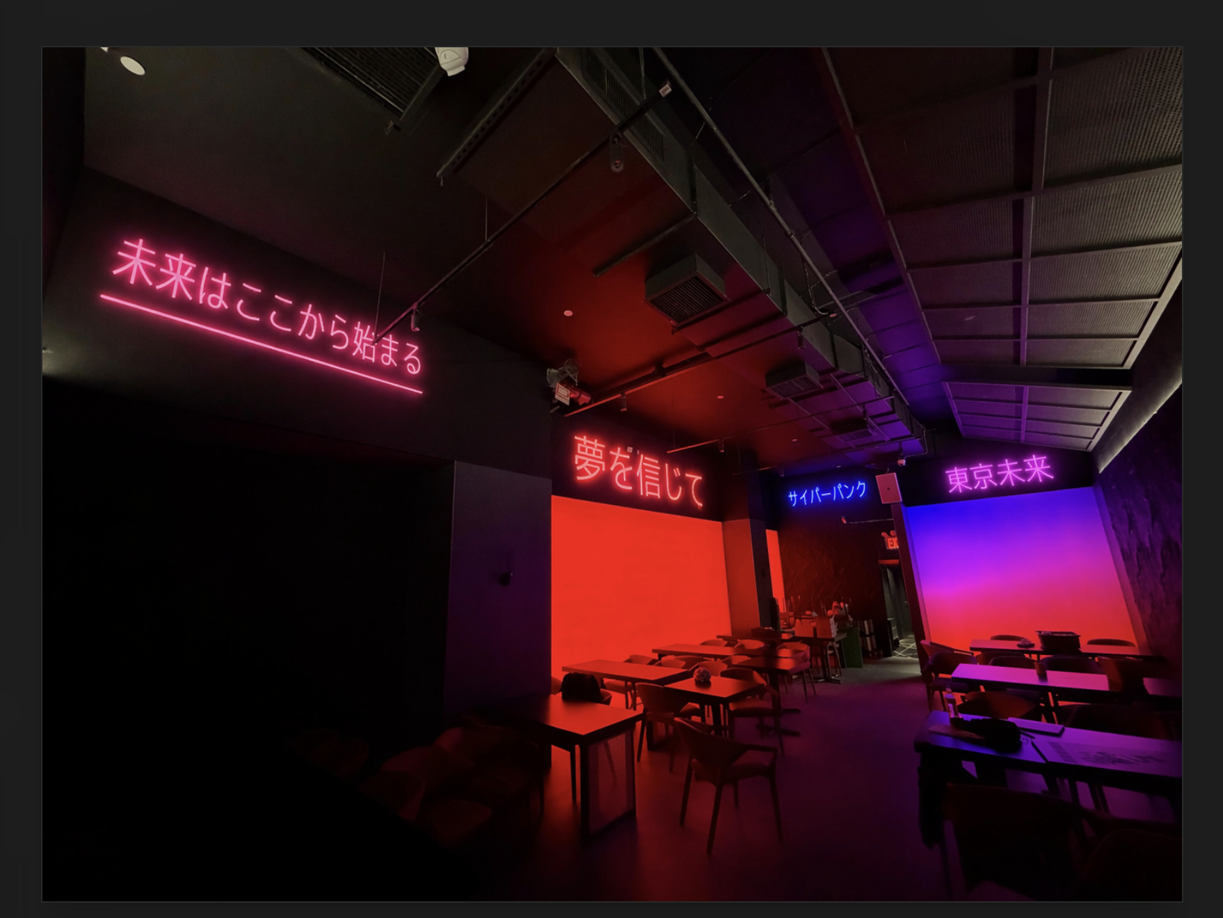 CHITORI dining room with neon Japanese signs and red-purple light