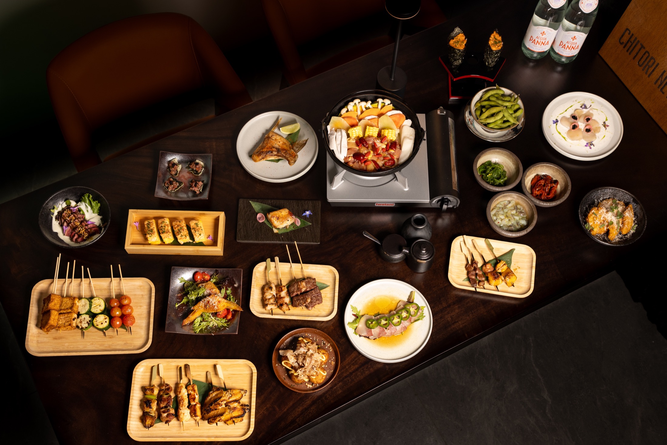 Shared plates, appetizers, and drinks spread across the table