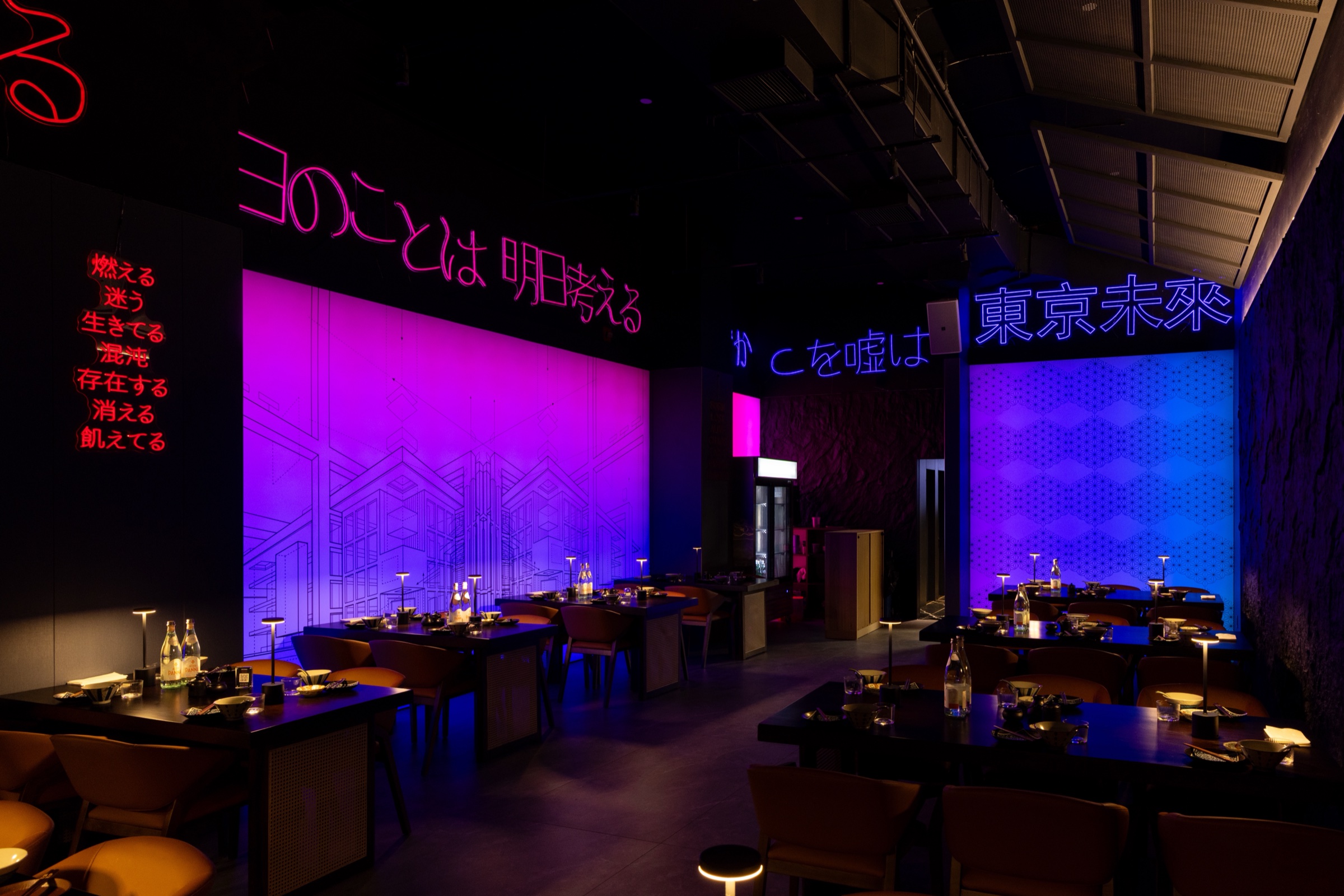 CHITORI dining room with neon Japanese signs and candlelit tables