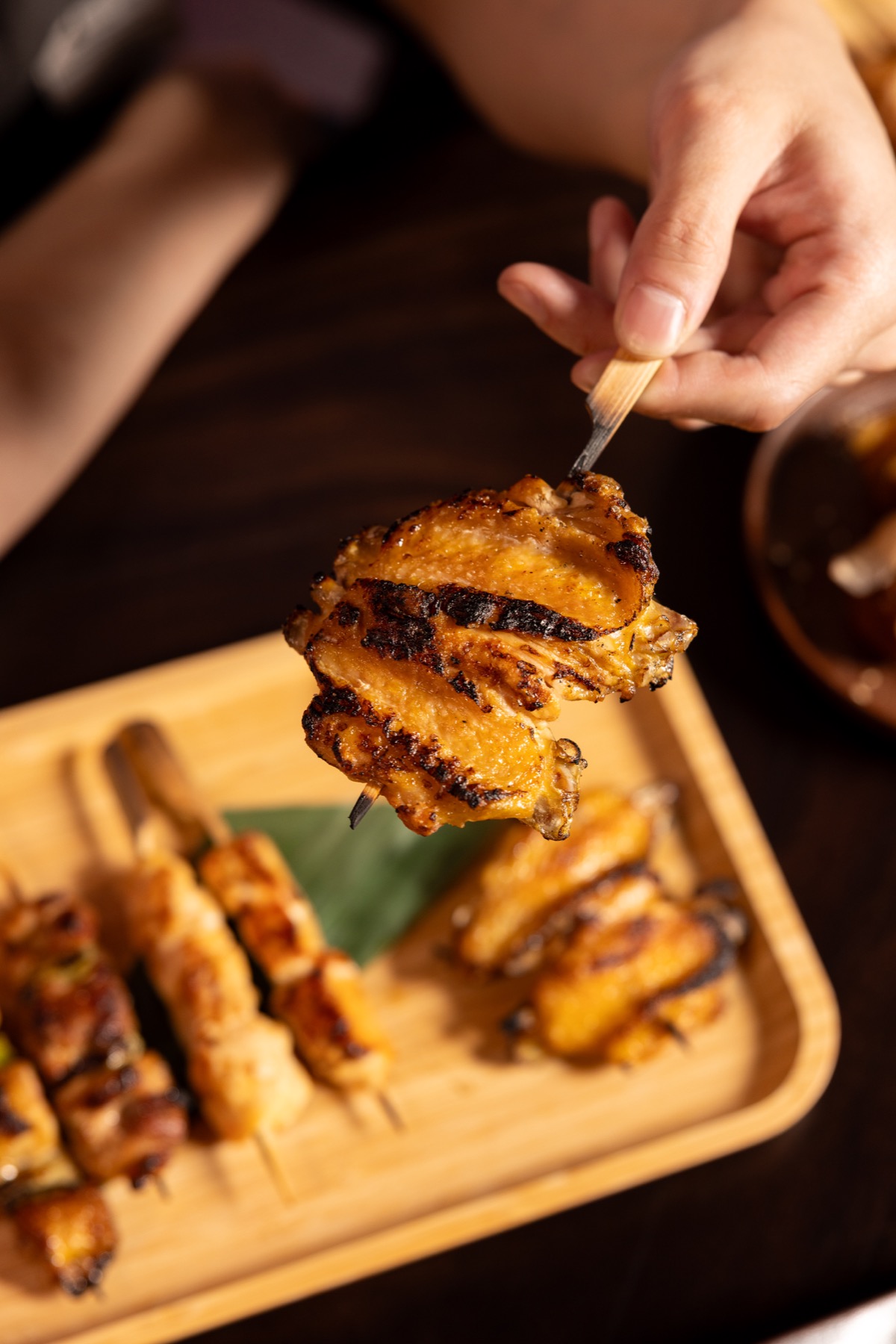 A close-up of grilled chicken wing yakitori